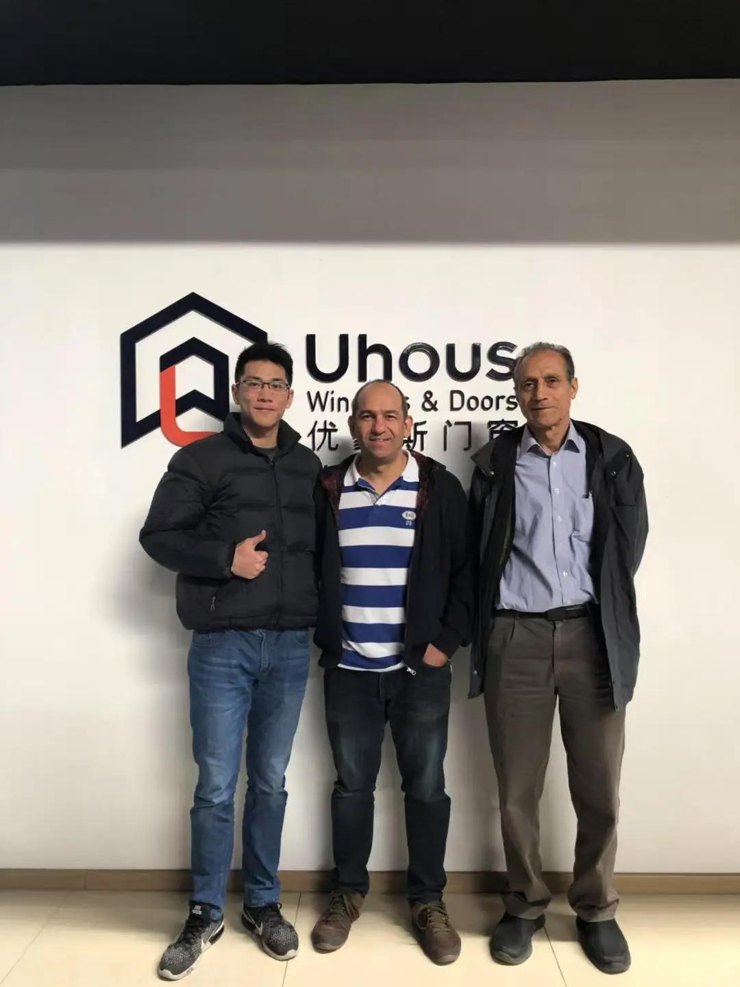 Uhous office with staff members discussing aluminum window project details