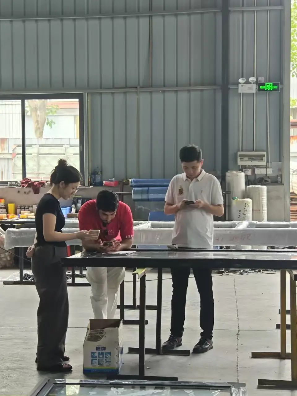 Guided workshop tour at Uhous factory showing aluminum window production process